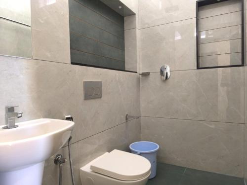 a bathroom with a sink and a toilet at Sea Breeze Cherai Homestay in Pallipuram