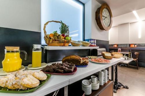 a breakfast table with pastries and fruit on it at Hotel Apolonia Soria in Soria