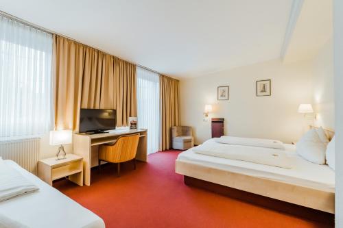 Postel nebo postele na pokoji v ubytování Hotel am Marschiertor