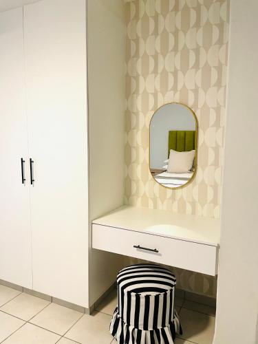 a dressing room with a mirror and a zebra stool at Atlantis Luxe escape Unit 25 in Uvongo Beach