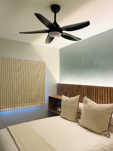 a ceiling fan in a room with a bed at Atlantis Luxe escape Unit 25 in Uvongo Beach
