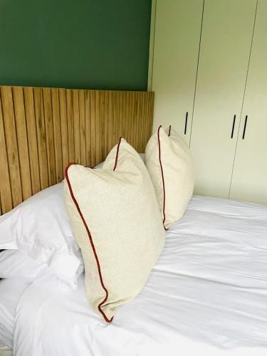 two pillows sitting on top of a bed at Atlantis Luxe escape Unit 25 in Uvongo Beach