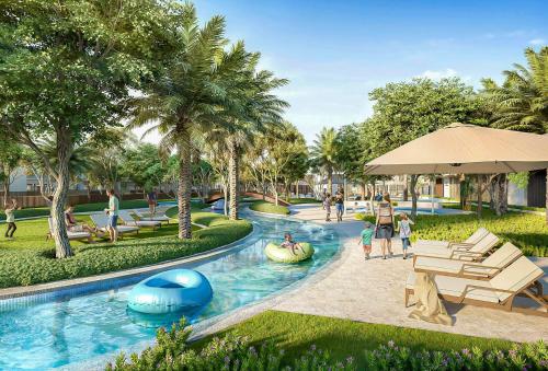 a pool at a resort with people playing in it at Dubai dream villa Emaar in Dubai
