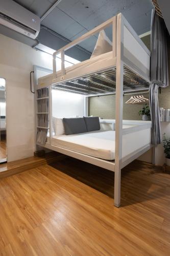 a bunk bed in a room with wooden floors at 109台北旅館-台北109青旅 109 Taipei Hotel - Taipei 109 Hostel in Taipei