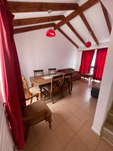a dining room with a table and chairs at Casa la Serena Puertas del mar in La Serena