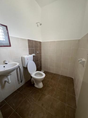 a bathroom with a toilet and a sink at FA Homestay in Pusing