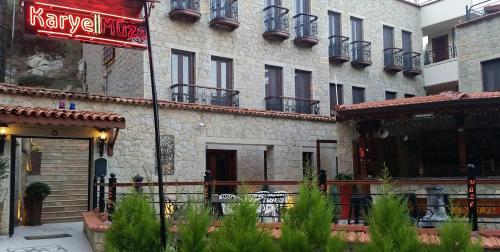 a building with a sign in front of it at Kazdaglari Karye Müze Hotel in Kucukkuyu