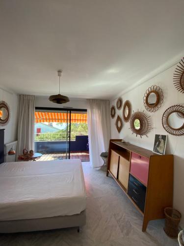 une chambre avec un lit et des miroirs au mur dans l'établissement Soleil et serenite au Cap Brun Toulon, à Toulon