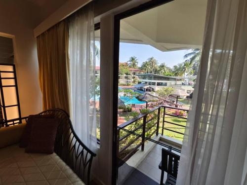 a room with a balcony with a view of a resort at Holiday Villa Resort & Beachclub Langkawi in Pantai Cenang