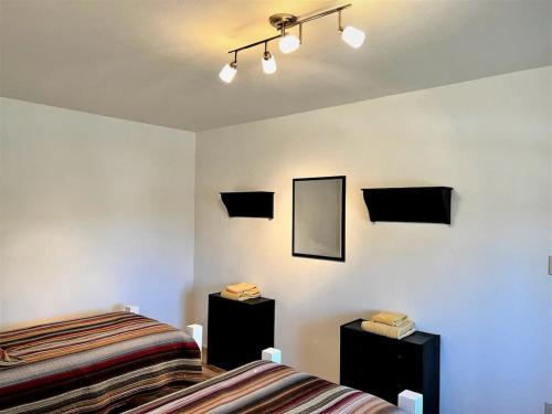 a bedroom with two beds and a mirror on the wall at CRC Ranch Retreat in Bandera