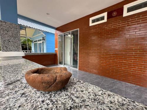 a large stone bowl sitting on the floor of a building at Garden Bungalows Koh Rong in Koh Rong