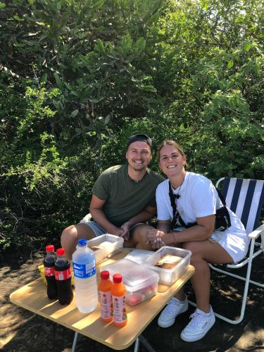 a man and a woman sitting on a picnic table at Bliss Inn in Udawalawe