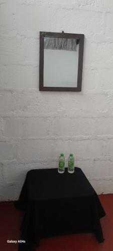 two bottles sitting on a table in a room at Pure Land Villa in Nallathaniya