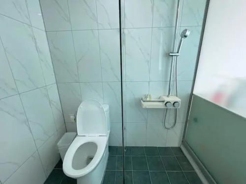 a bathroom with a toilet and a shower at Hotel Haeundae Elysia in Busan