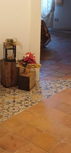 a vase of flowers sitting on a tile floor at Casa Sangineto - Minori - Costa Amalfitana- A Paradise in the countryside in Minori