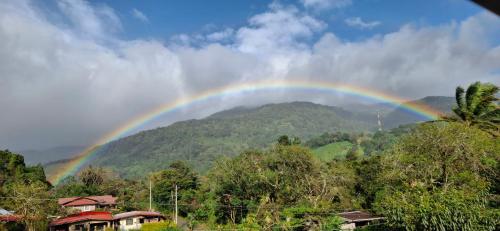 a rainbow in the sky over a mountain at Hotel La Casa de la Abuela in Boquete