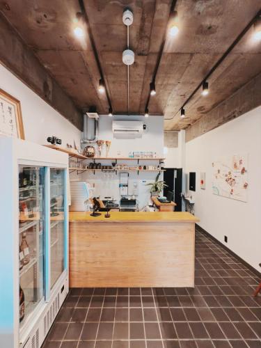 a large kitchen with a counter in a room at HERE.Tokyo in Tokyo