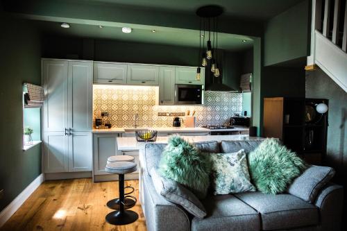 a living room with a couch and a kitchen at Croft View in Hayton