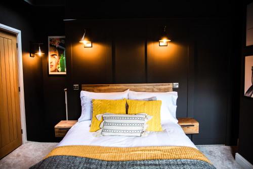 a bedroom with a bed with yellow pillows at Croft View in Hayton
