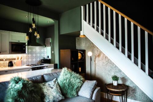 a living room with a couch and a staircase at Croft View in Hayton