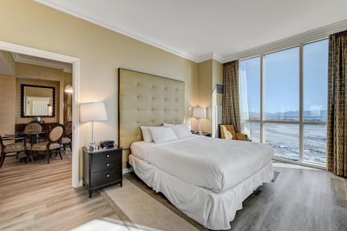 a bedroom with a large bed with a large window at Signature MGM 1 Bedroom Penthouse Suite in Las Vegas