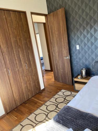 a bedroom with wooden cabinets and a bed with a rug at Niseko Forest Avenue 63 in Niseko