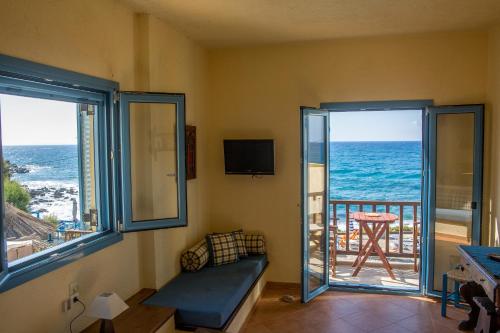 a living room with a view of the ocean at Porto Sisi Hotel Apartments in Sissi