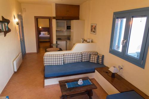 a living room with a couch and a table at Porto Sisi Hotel Apartments in Sissi