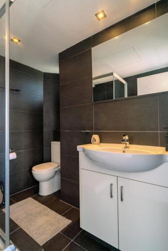 a bathroom with a sink and a toilet at Element Stays City Suite in Nicosia