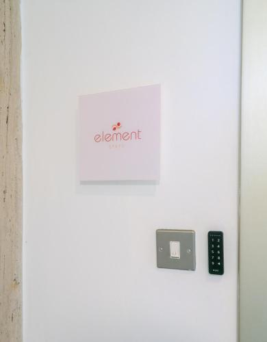 a door with a alert sign and a remote control at Element Stays City Suite in Nicosia