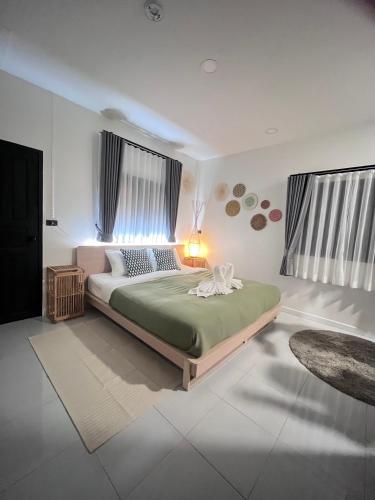 a bedroom with a large bed in a room at 7Senses Resort in Ko Chang