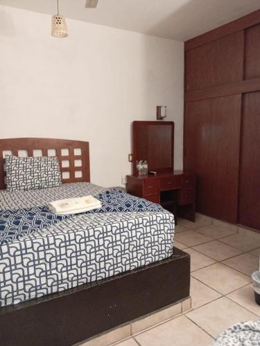 a bedroom with a bed and a dresser and a bed sidx sidx sidx sidx at Hotel Colonos Los Cabos in Cabo San Lucas