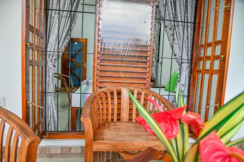 a wooden chair sitting in front of a window at Turtle cove residence in Tangalle