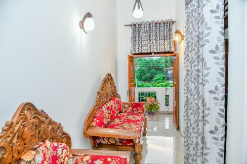 a living room with a couch and a window at Turtle cove residence in Tangalle