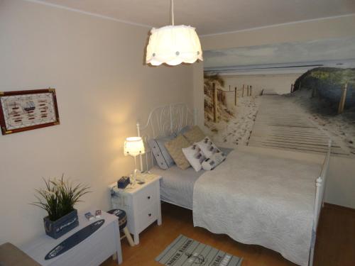 a bedroom with a bed and a table with a lamp at SEA Apartment in Hel