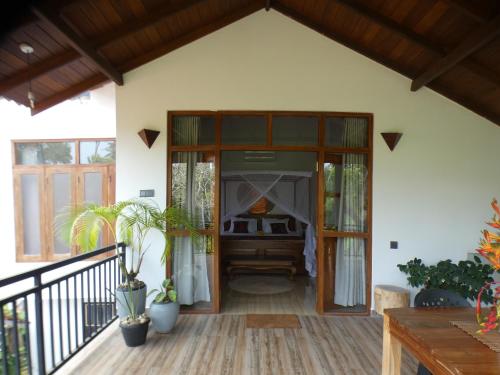 a porch of a house with a door open at Lisha Mawella in Tangalle