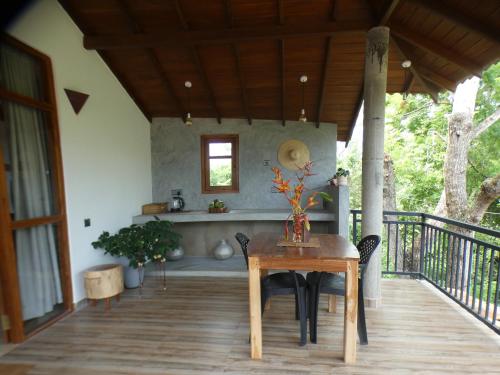a wooden table and chairs on a porch at Lisha Mawella in Tangalle