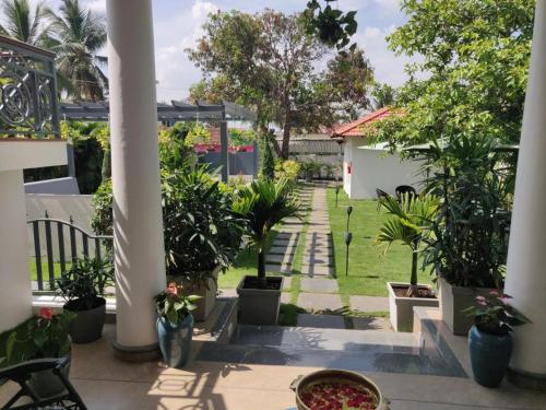 a patio with potted plants and a yard at The Elegant homes in Kushālnagar