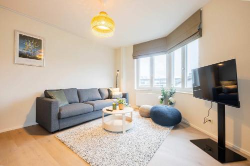 a living room with a couch and a tv at Royal 60m2 One Bedroom Apartment - VW140A in Eindhoven