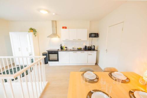 a kitchen and dining room with a table and chairs at Royal 60m2 One Bedroom Apartment - VW140A in Eindhoven