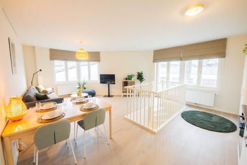 a living room with a table and chairs and a couch at Royal 60m2 One Bedroom Apartment - VW140A in Eindhoven
