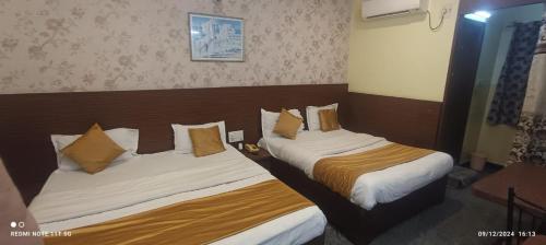 a hotel room with two beds in a room at Hotel nav bharath residency in Hyderabad