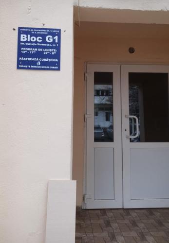a blue sign on the side of a building with a door at Dream Studio Airport & Mall Craiova in Craiova
