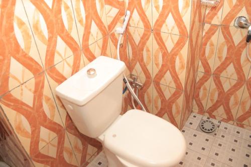 een badkamer met een wit toilet in een kamer bij Afrika Nomades in Abidjan