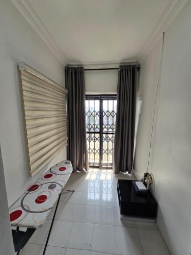 a room with a bed and a large window at Crasto Suites in Ikeja