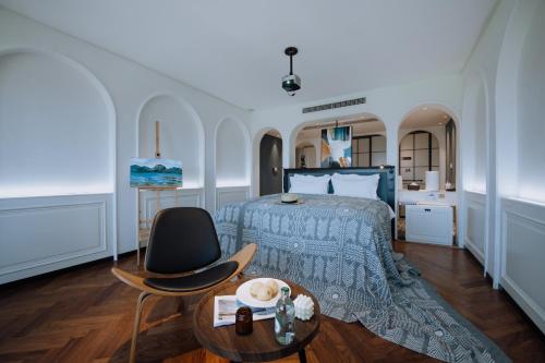 a bedroom with a bed and a table and a chair at Lakeside Retreat - LuguLake Lijiang in Zuosuo