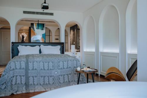 a bedroom with a bed and a table at Lakeside Retreat - LuguLake Lijiang in Zuosuo