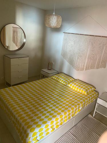 a bedroom with a bed and a mirror at Acogedor apartamento con terraza in Cedeira