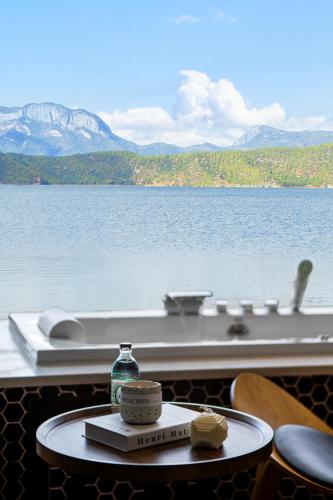 a view of a boat on the water at Lakeside Retreat - LuguLake Lijiang in Zuosuo