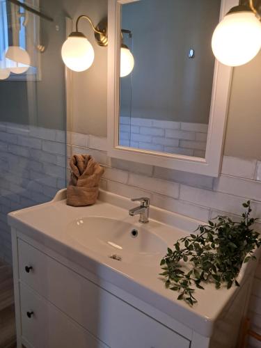 a bathroom sink with a mirror and a towel at Asos Luxury Seafront Villas, Kefalonia, 100m beach & center, 4 stars services, Parking - near Myrtos - Fiskardo in Asos